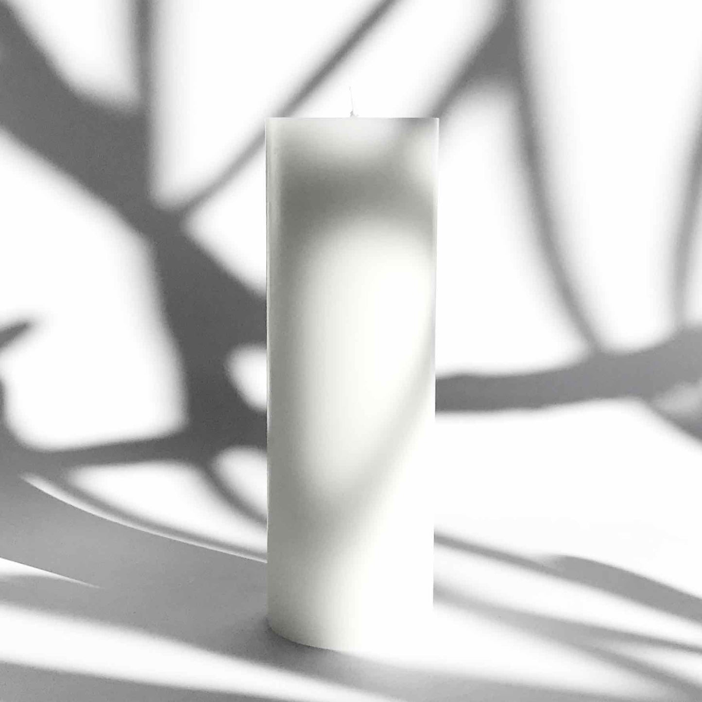 Tall white pillar candle