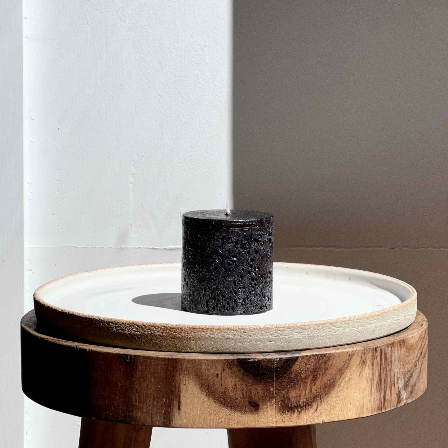 Small black textured pillar candle