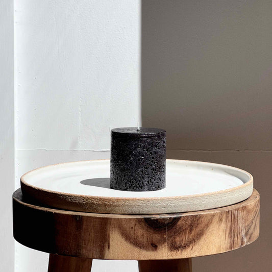 Small black textured pillar candle