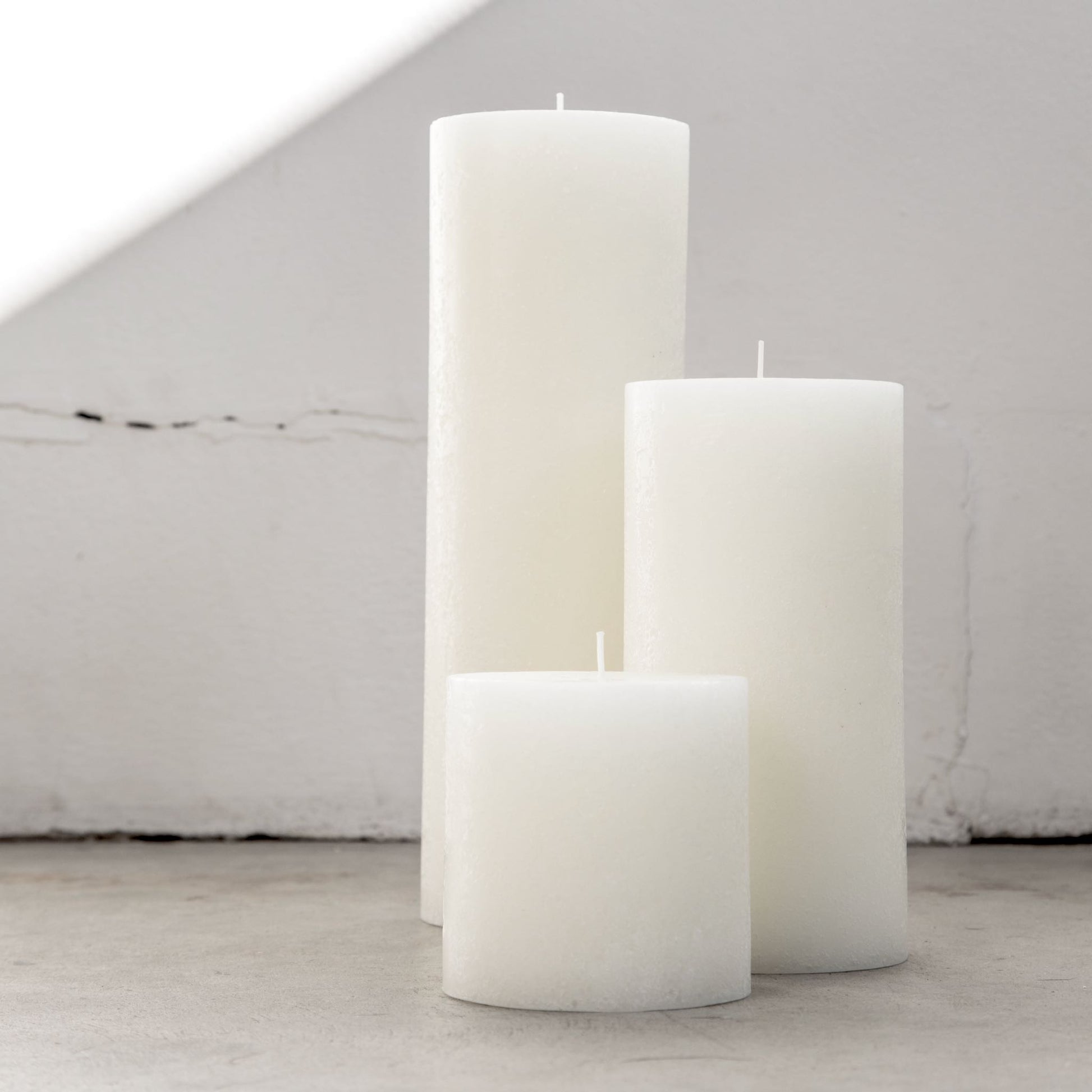 Large textured candles in warm white