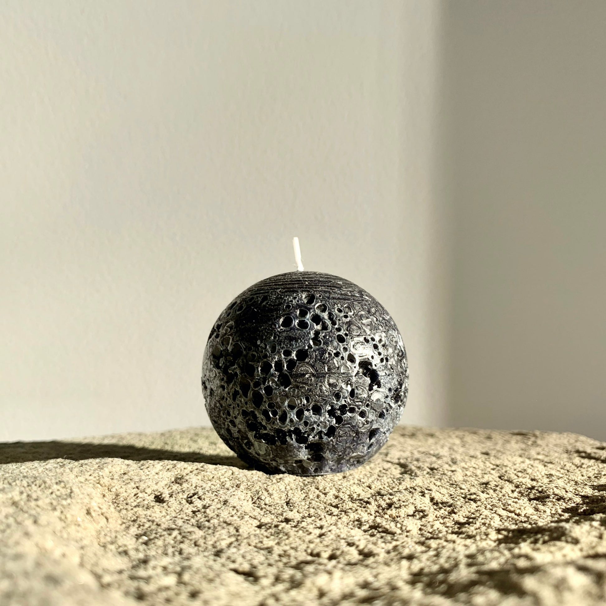 Rustic black sphere candle
