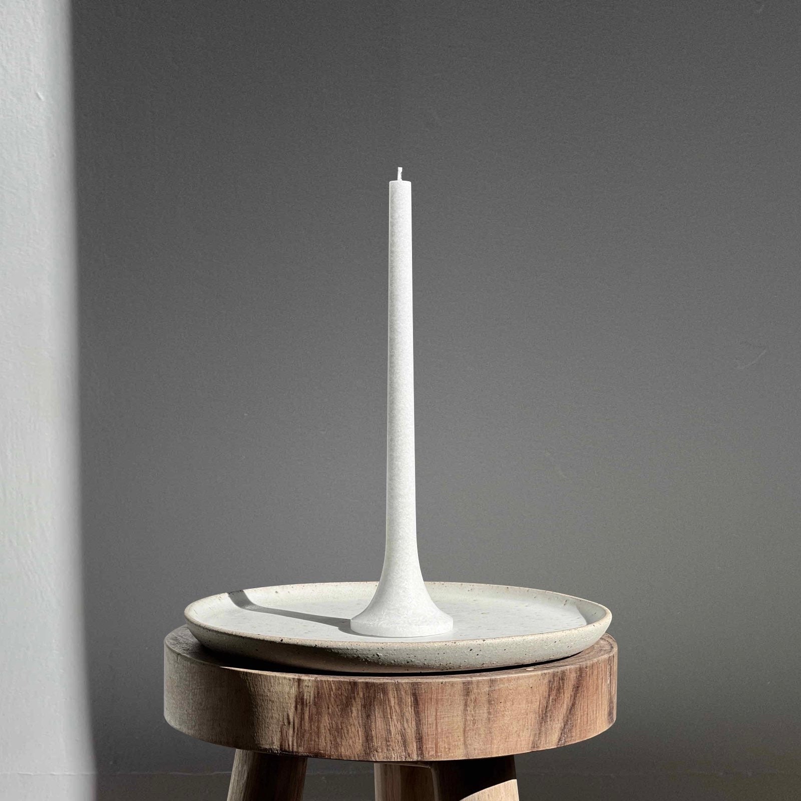 Tall white taper candle